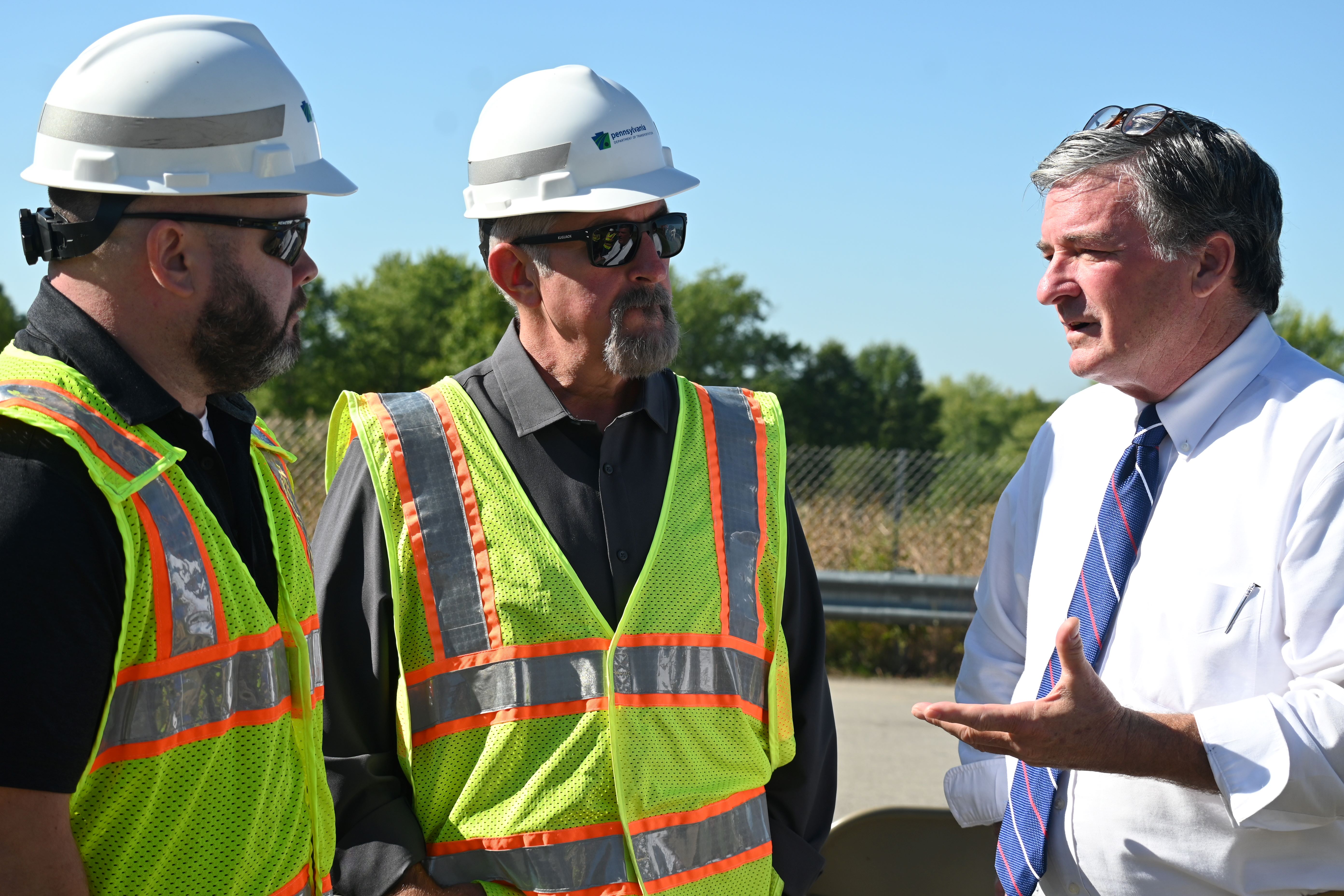 PennDOT Secretary Mike Carroll discusses the Route 318 bridge project with PennDOT employees Zach Miles and Ralph